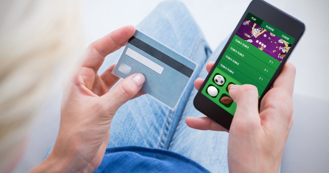 Persona usando un teléfono con una plataforma de apuestas online, reflejando preocupación y estrés
