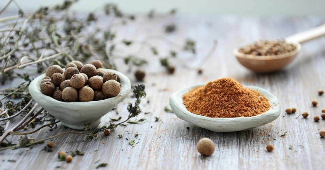 Olla aromática con canela y nuez moscada hirviendo en una cocina