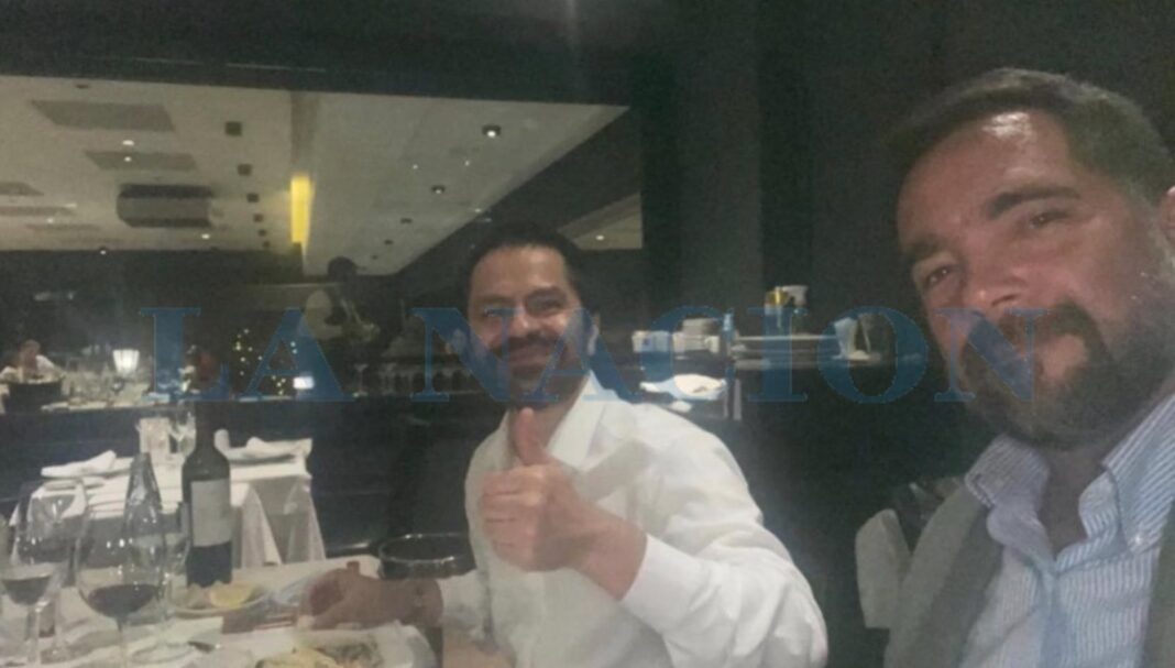 Fotografía de Facundo Leal cenando con Juan Bonora, vicepresidente de Huawei, en un restaurante con vino en la mesa